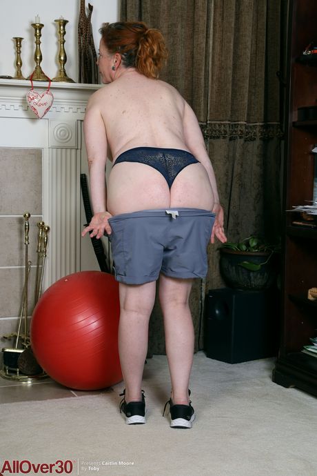 Redheaded BBW Caitlin Moore shows her big tits and spreads her twat