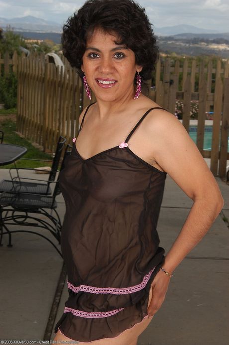 Mature woman Majal shows her bush after removing her nightgown