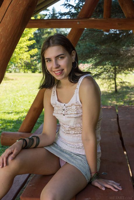 Winsome teen Zhenya Mille gets naked on a picnic table confidently