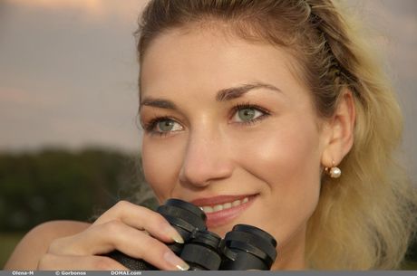 Delicate teen Olena M poses totally naked in a field of tall grass