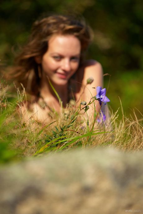 Redheaded teen Paola poses naked in the forest to show her tiny tits & ass