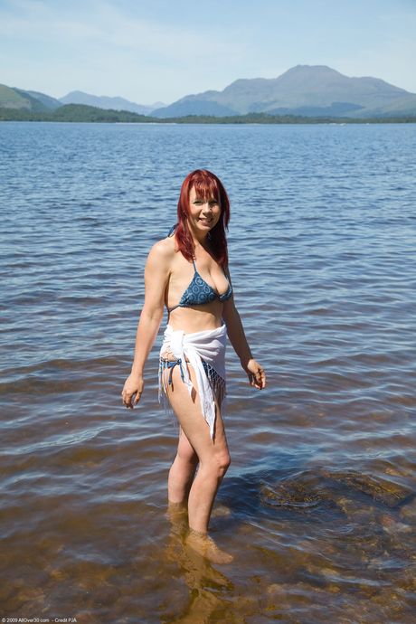 Mature redhead Shannon H strips off her bikini and shows her hot body