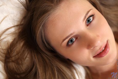 Blonde beauty Nimfa takes off her bra and panties before showing her pink pussy