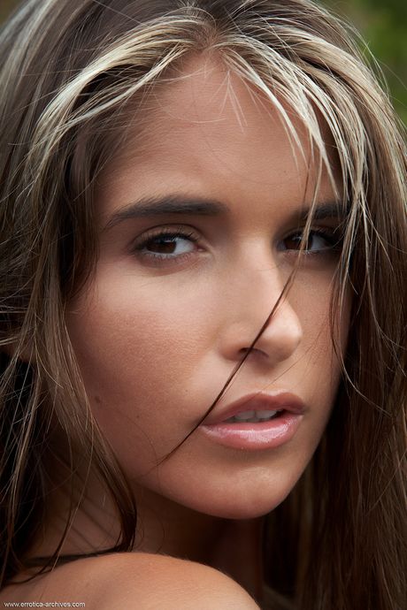 Brunette teen Nessa strips off on a sandy beach