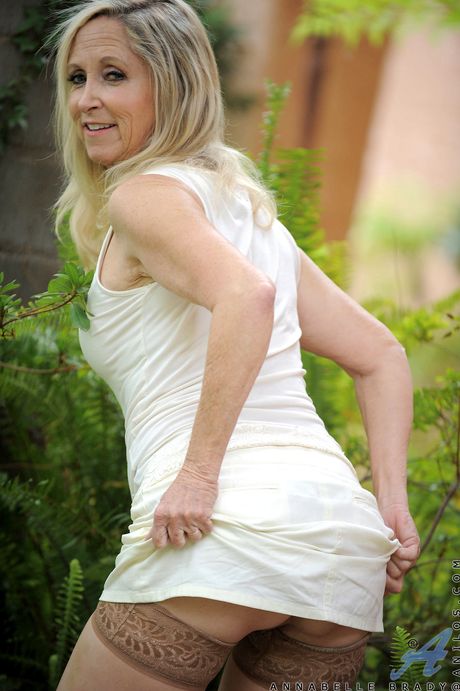 Mature blonde Annabelle Brady shows her big ass and fingers her pussy