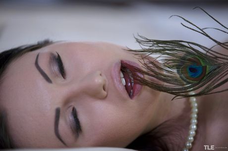 Sasha Rose shows off her pierced pussy and fingers it with a feather