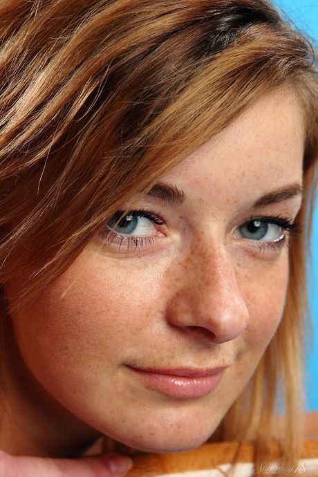 Attractive teen Ekaterina D gets naked on a bed before licking her pussy