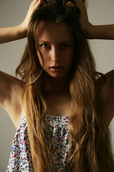 Svelte teen Milana K poses nude in the shadows of a cave