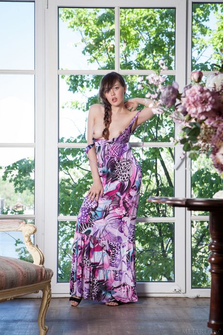 Stunning teen Ulia removes her hair from her pigtails while getting naked