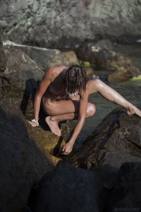 Young beauty Eddison takes off everything on a sandy beach
