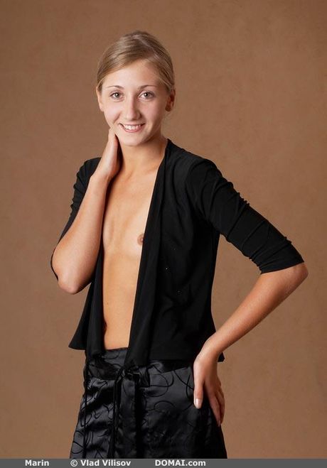 Lean teen Marin poses naked in the kitchen to show her tiny tits and ass