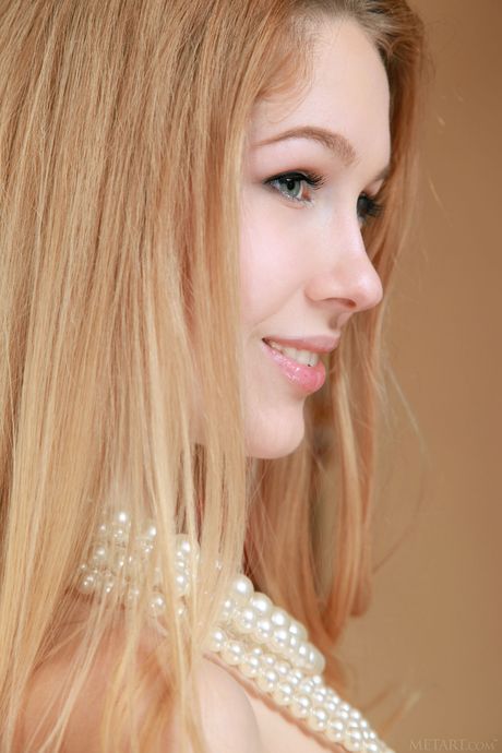 Charming teen Genevieve Gandi removes her lingerie and poses naked on the bed