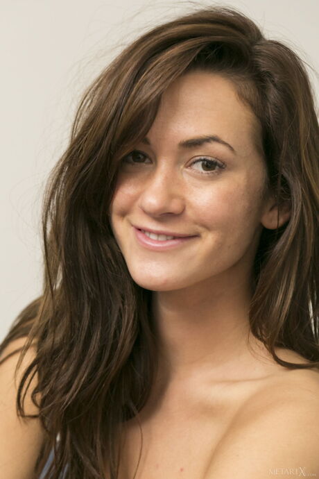 Brunette teen Tess B fingers her pussy after removing her bikini