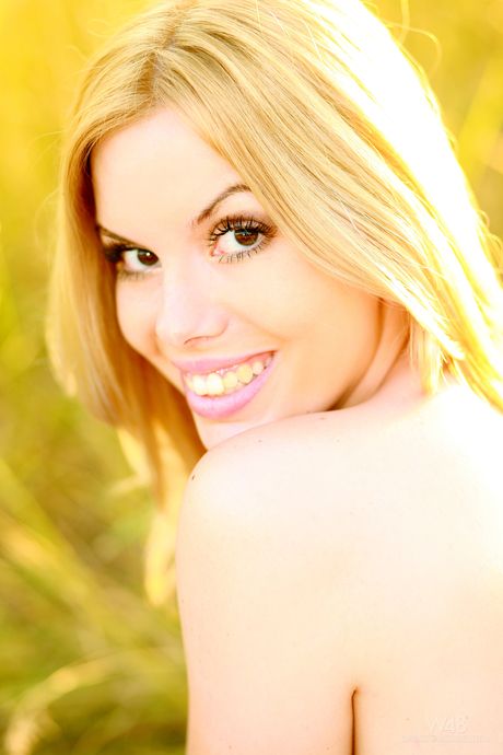 Skinny blonde Kala Ferard exhibits perfect body in a field of wheat by herself