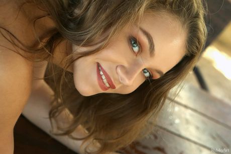 Alisa Lisa exhibits her sexy body as she poses on the bed