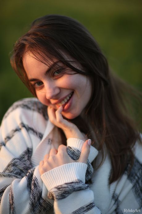 Young brunette Sofy Bee gets nude in a field of wildflowers