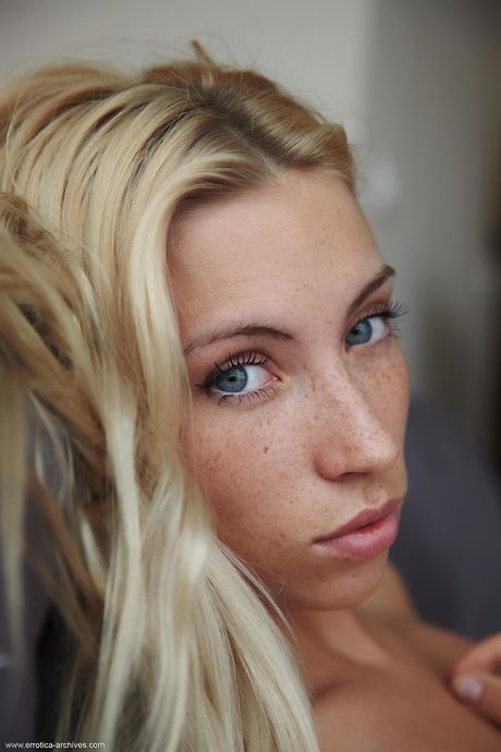 Winsome teen Adele sports a landing strip pussy while showing her naked body