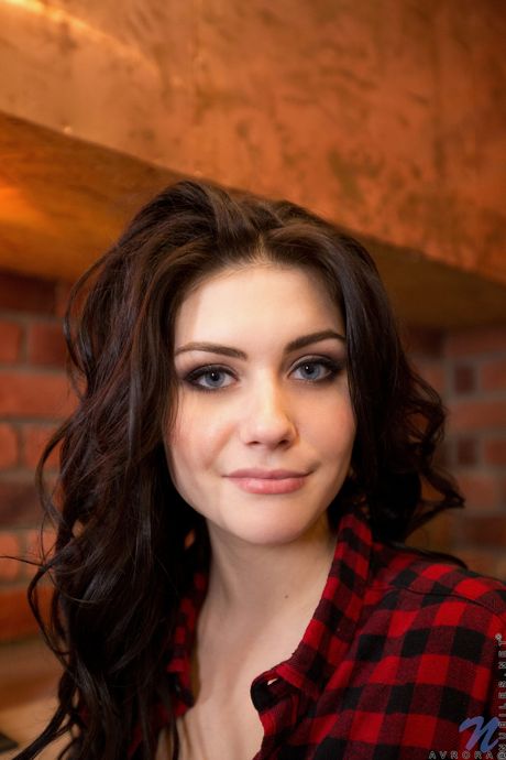 Teen Avrora toys her shaved pussy with a glass dildo on the bed