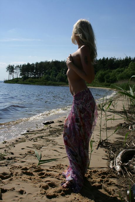 Blonde teen Tanusha A gets naked on a beach and in a cave