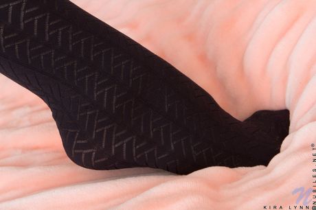 Alluring teen Kira Lynn removes red lingerie before masturbating in stockings