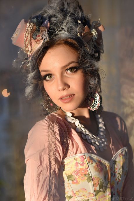 Magnetic teen Lily Sands removes her corset and stockings to pose nude