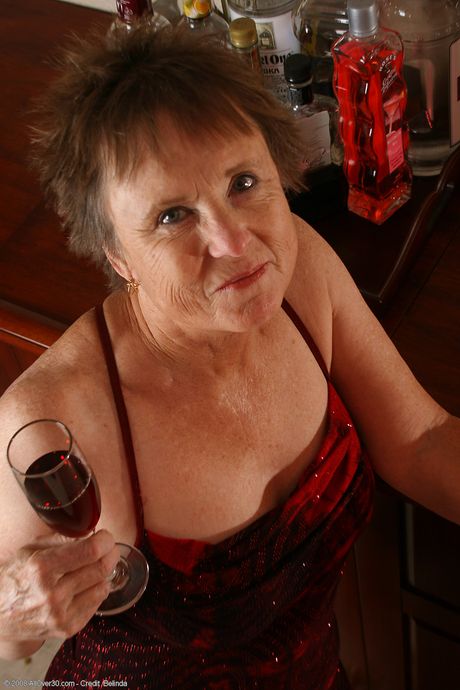 Granny Sandra D shows her big tits and exhibits perfect body in her kitchen