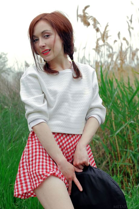 Petite teen Night A strips naked in the backyard and shows her tasty pussy