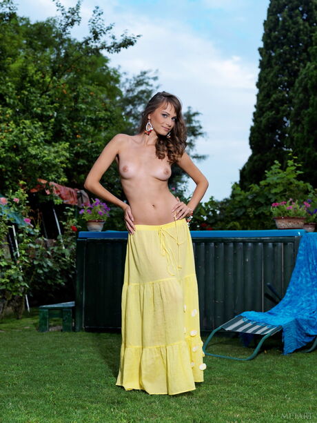 Thin teen Julia I strips and poses nude in the middle of a forest