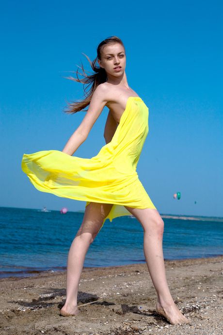 Alluring teen Sofy B strips off her bikini and teases with her shaved pussy