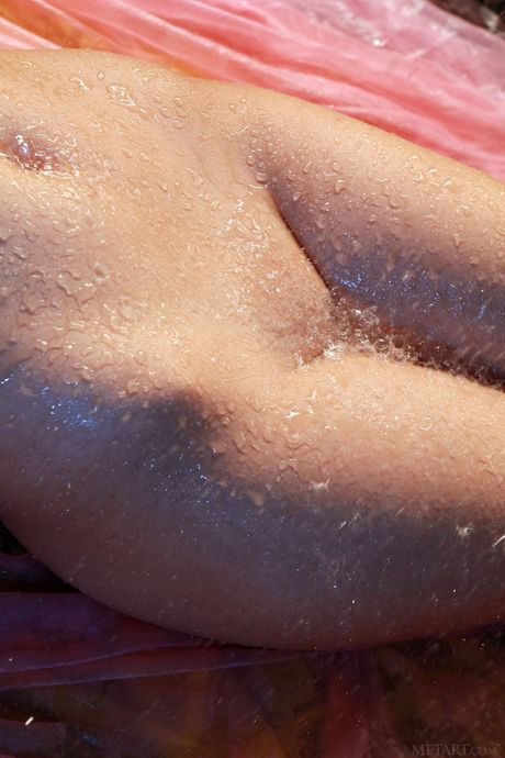 Svelte teen Nikia A removes her white dress to pose nude in a bathroom