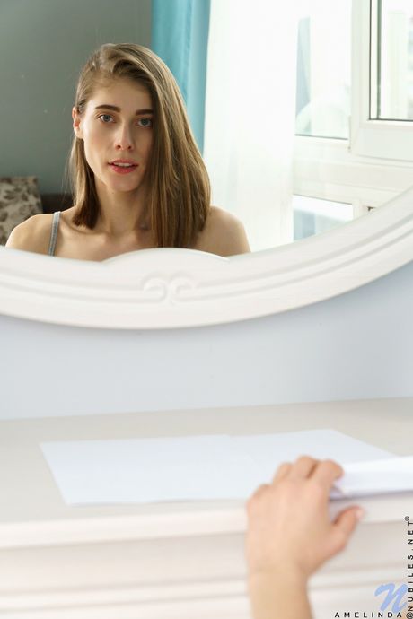 Pretty teen Amelinda strips and fingers her pussy in her bedroom