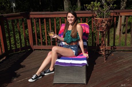 Petite teen Mackenzie Mace attaches clamps to her pussy in the backyard