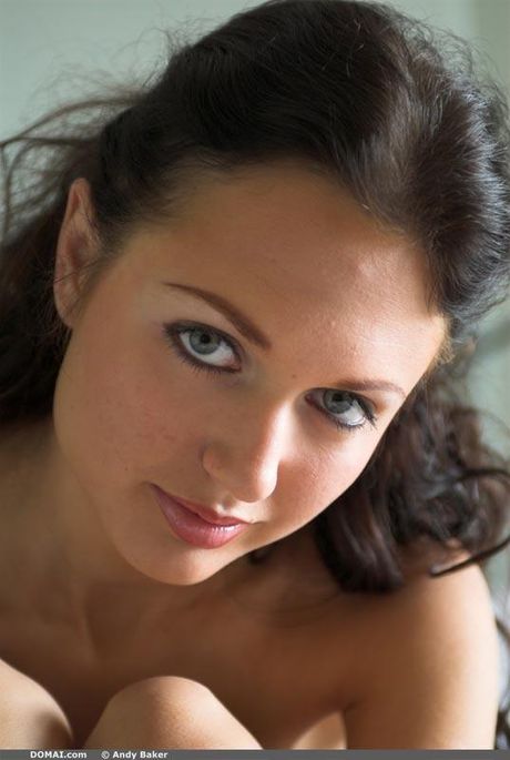 Charming teen Milana poses naked fearlessly on a bed