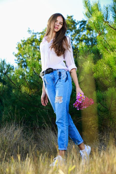 Gorgeous teen Valencia strips naked in a field & spreads her pussy lips