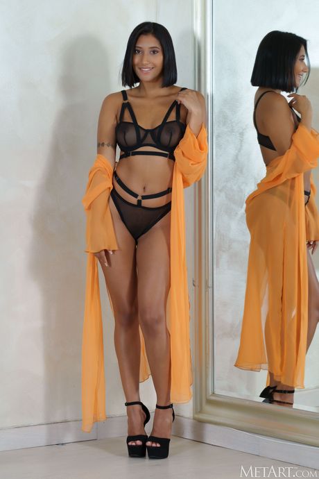 Intriguing teen Alika Penagos removes her lingerie and heels to get naked