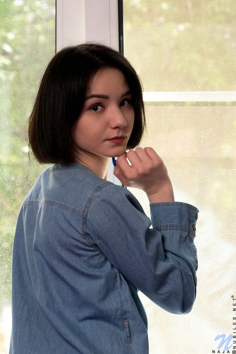 Alluring teen Naja takes off her lingerie and presents her shaved pussy on a bed