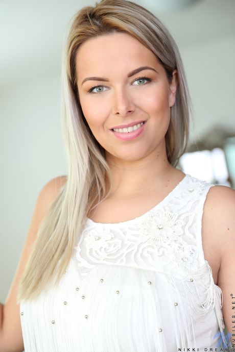 Blonde babe Nikki Dream unveils her big natural tits and pink pussy