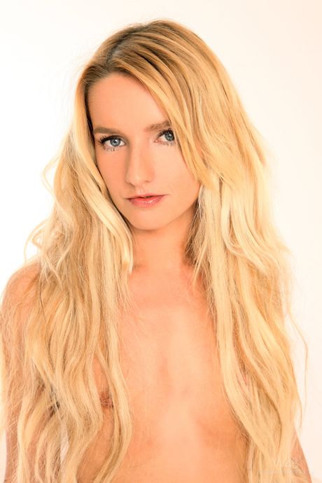 Blonde girl Megann shows her tiny tits and trimmed vagina in a solo