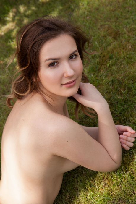 Winsome teen Anata removes her lingerie to pose nude on a blanket in the shade