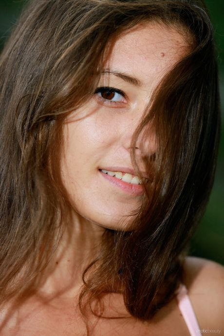 Thin teen Rosella shows her small tits & poses naked in the long grass