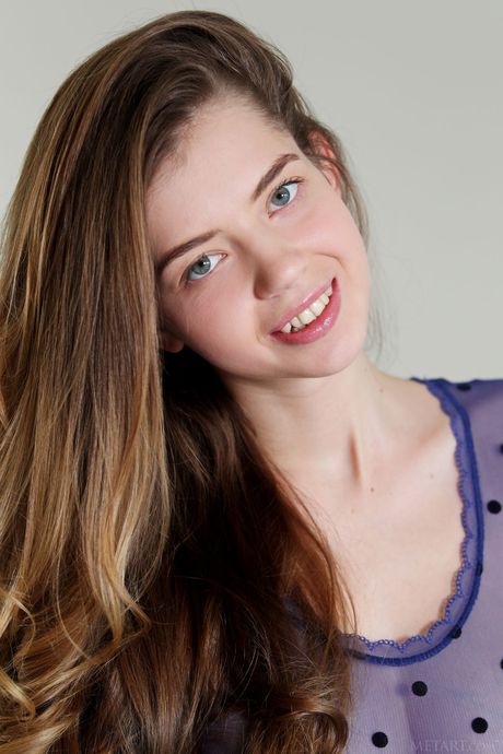 Intriguing teen Kay J removes her lingerie and high heels to pose nude