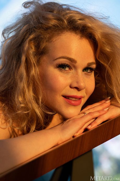 Adorable teen Helena gets naked on a balcony before showing her tight slit