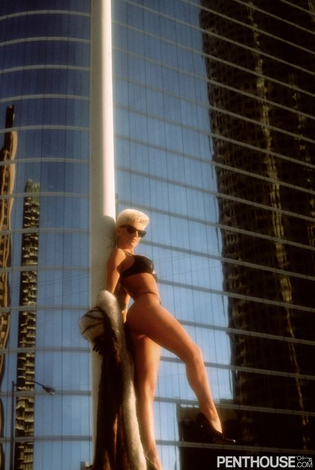 Blonde centerfold Jaqueline Winfield exhibits her big tits and ass outdoors