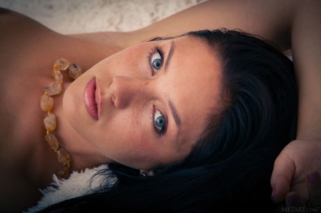 Solo girl with long black hair and a tight ass models in the nude