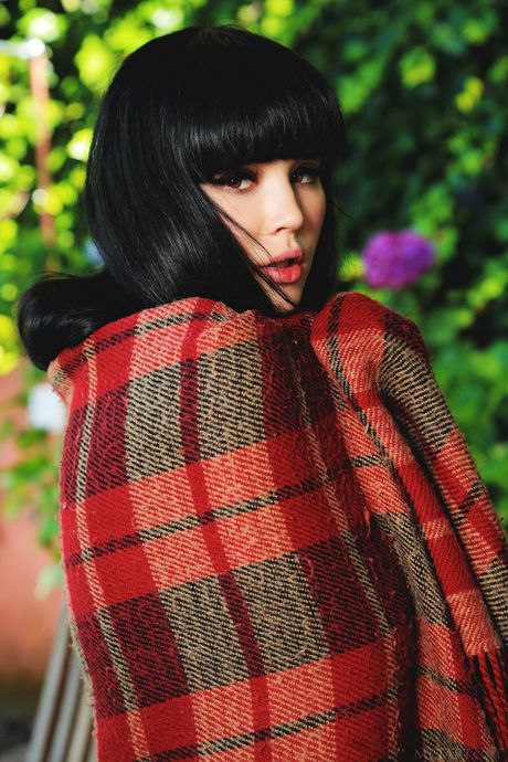 Alluring teen Malena removes her blue dress and stockings to pose nude in the yard