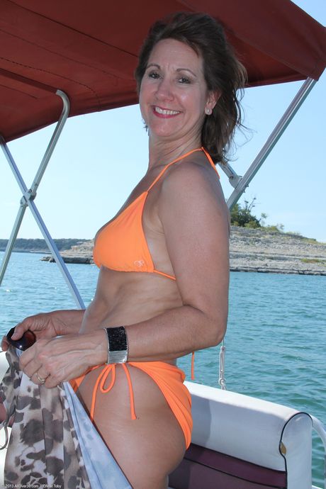 Older woman Lynn shows her saggy tits and bald pussy on a boat