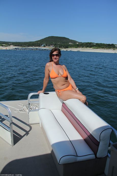 Older woman Lynn shows her saggy tits and bald pussy on a boat