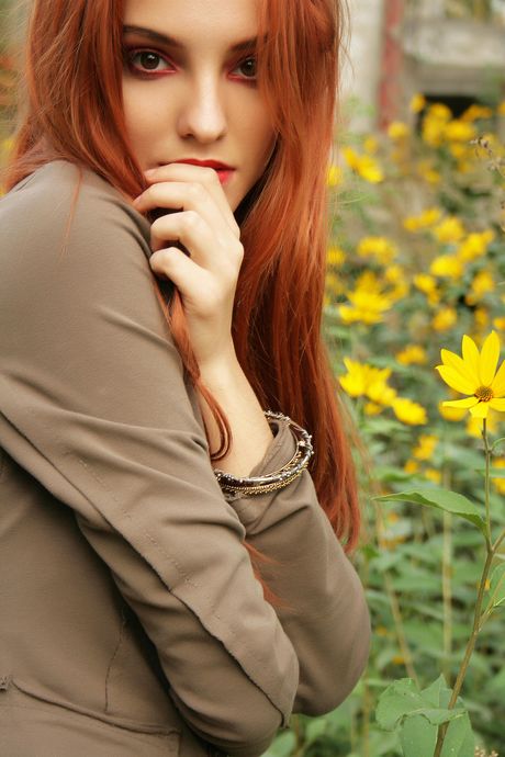 Sexy redhead Kira W smokes a cigarette after getting naked in a basement