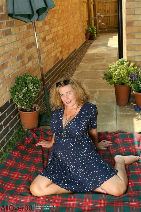 Chubby MILF Camilla A shows off her big tits and her big ass outdoors