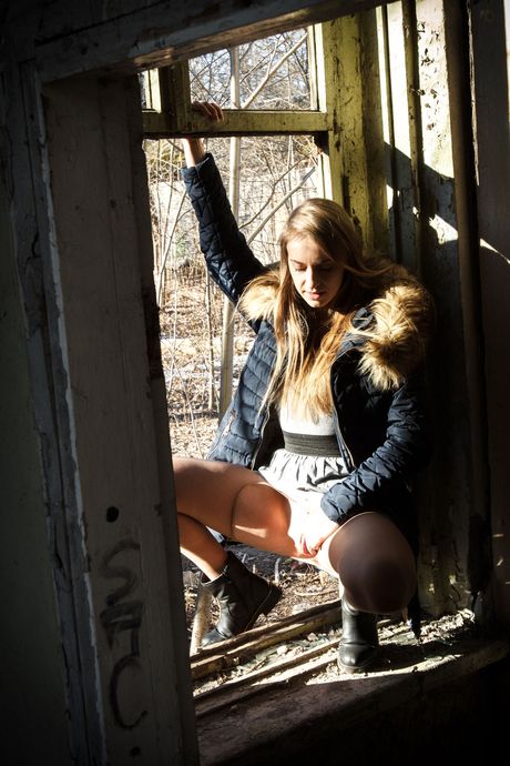 Alluring teen Izabella K strips to her boots and fingers her pussy outdoors